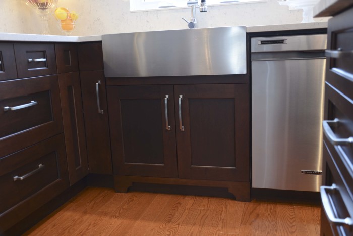 dark maple cabinetry with farm sink and details